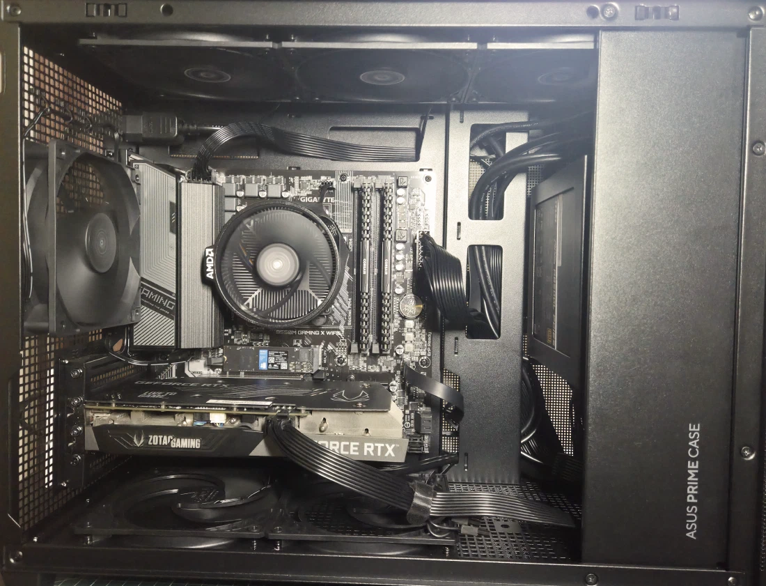 Inside the finished build — Ryzen 5 5600 with stock cooler, Gigabyte B550M board, Zotac RTX 3060, and the cabling tucked into the Asus Prime AP201