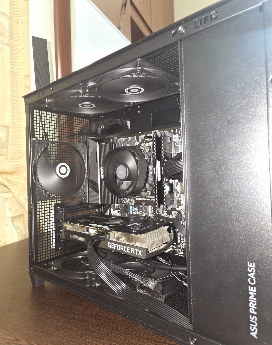 Angled view of the build in the AP201 with the side panel off, showing the intake and exhaust fan layout around the GPU and CPU cooler